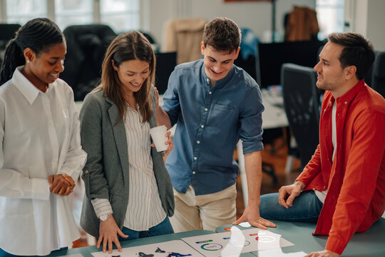 Marketing team analyzing charts and graphs during collaborative meeting