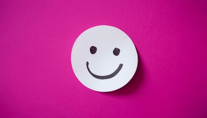 Fototapeta premium White sticky paper note with drawn happy emoji face on pink background. Emotion, mental state