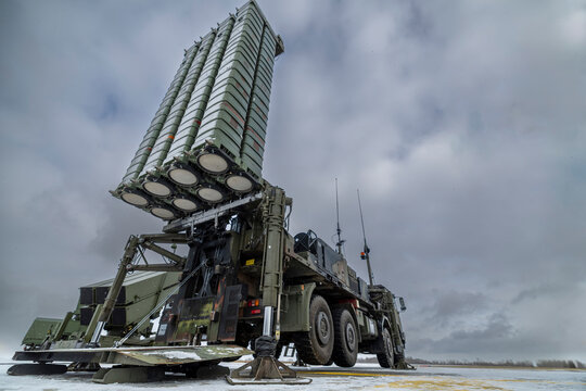 A SAMP T air defense system with Aster 30 missiles deployed on a military truck in a snowy environment under a cloudy sky.