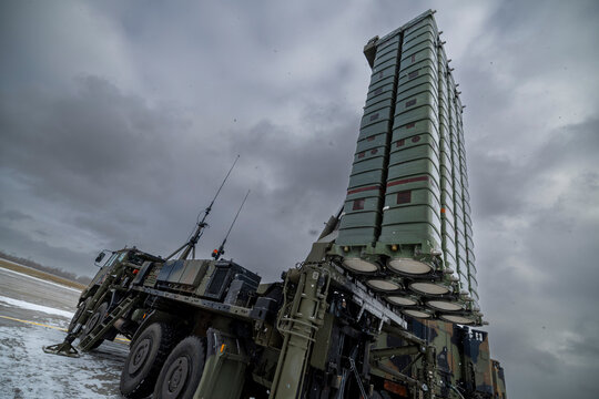 A SAMP T air defense system with Aster 30 missiles deployed on a military truck in a snowy environment under a cloudy sky.