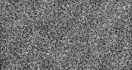 Black and white background with flecks resembling the texture of marble chips.	