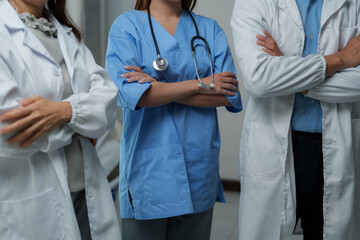 Medical team standing with crossed arms in hospital