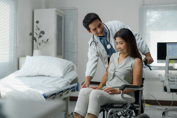 Obraz premium Doctor pushing a senior woman in a wheelchair in hospital room