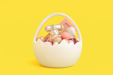 Basket in shape of eggshell with decorative cosmetics and Easter eggs on yellow background