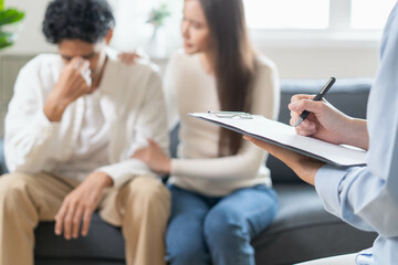 Spouses relationship consultant concept, Close-up hands of psychologist holding pen and note during...