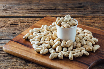 Peanuts on wooden background