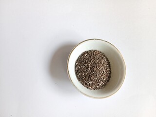 Bowl of Chia Seeds on White Background