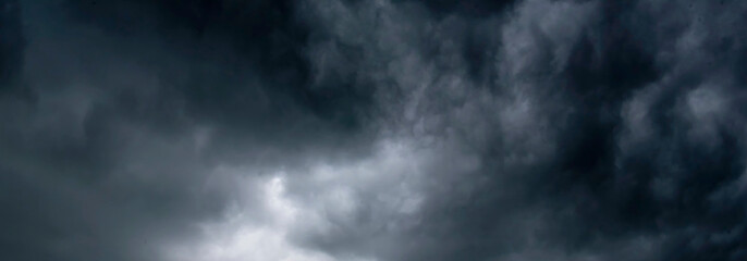 Banner Dramatic dark storm clouds black sky background. Dark thunderstorm clouds rainny season. Panorama Meteorology danger windstorm disasters climate. Dark cloudscape storm cloud with copy space.