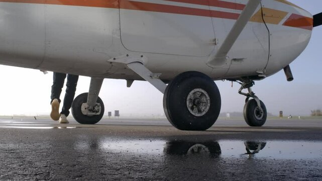 Static View of Tricycle Landing Gear of Propeller Airplane with Pilot