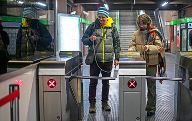 happy teenage daughter and father go through the turnstiles in the subway. Everyday life