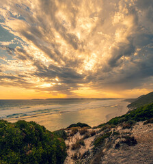 Dramatic sunset seascape with approaching thunderstorm clouds 