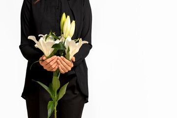 Young woman with funeral bouquet of lily flowers on white background