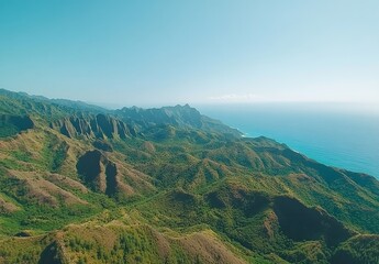Aerial View of the Na Pali Coast, Kauai, Hawaii, Featuring Jagged Mountain Ridges, Lush Green Vegetation, Steep Cliffs Meeting the Turquoise Ocean, and a Clear Blue Sky.


