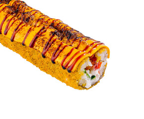 Sushi roll is lying on a white surface, covered in sauce and sesame seeds
