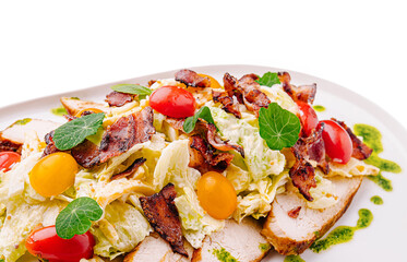Fresh salad topped with crispy bacon and juicy tomatoes served