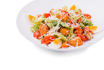 Fresh salad with shrimp, vegetables, and herbs on a white plate
