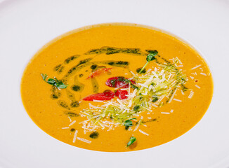 Creamy pumpkin soup with herbs and spices garnished beautifully