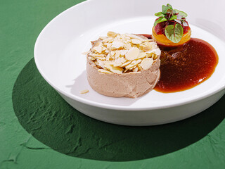 Delicious dessert featuring almond toppings and fruit coulis