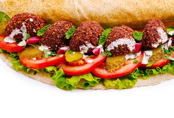 Delicious falafel wrap filled with fresh vegetables and sauce