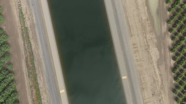 Overhead aerial view aqueduct canal flowing through farmland