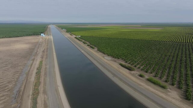 Aerial view California aqueduct canal running through farmland