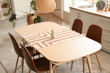 Dining table with vase in light kitchen
