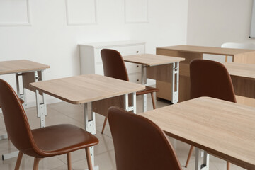 Interior of empty classroom with school desks