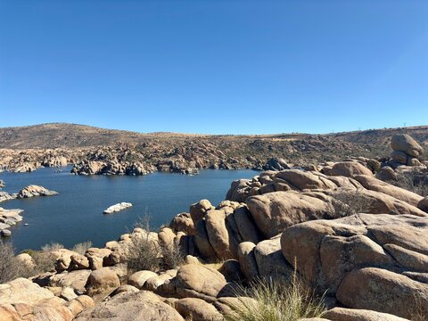 Scenic view of Watson Lake with large boulders and deep blue reservoir