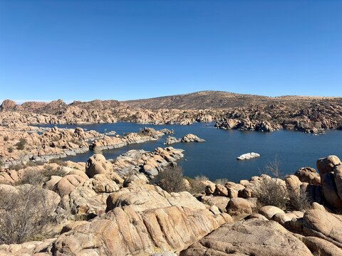 Expansive view of Watson Lake with rugged rock formations, calm waters
