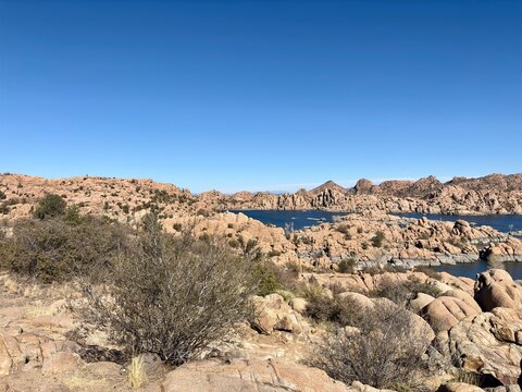 Scenic view of Watson Lake with rocky terrain and desert vegetation