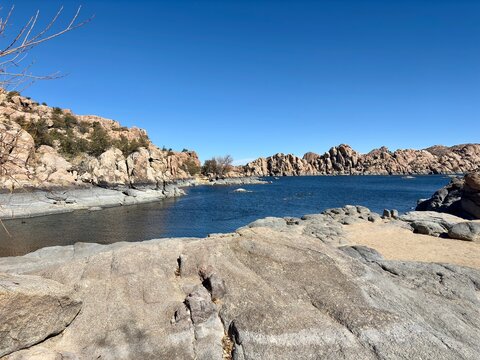 Rocky shoreline of Watson Lake in Prescott, Arizona, under clear sky