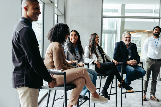 Corporate panel discussion with diverse professionals in modern office setting