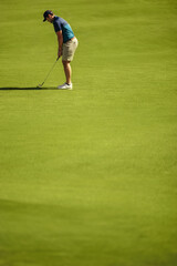 Fototapeta premium Focused professional golfer at golf resort preparing for a challenging game