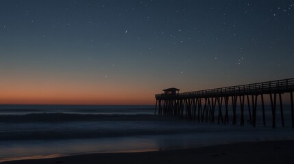 Fototapeta premium Night sky over ocean pier silhouette.