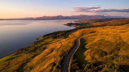 Fototapeta premium Coastal road winds through golden hills at sunset