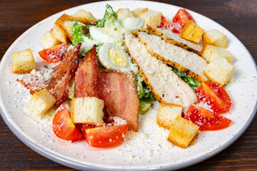 Tasty salad with crispy bacon, grilled chicken, and veggies