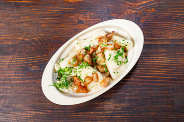 Delicious dish of dumplings topped with crispy bacon and herbs