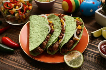 Traditional Mexican tacos and maracas on wooden background, closeup. Cinco de Mayo (Fifth of May) celebration