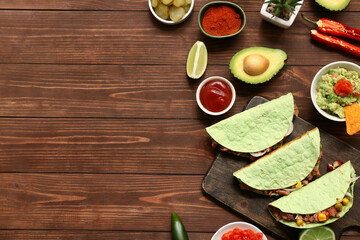 Traditional Mexican tacos and guacamole on wooden background. Cinco de Mayo (Fifth of May) celebration