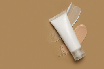 Tube of cosmetic product and samples on color background
