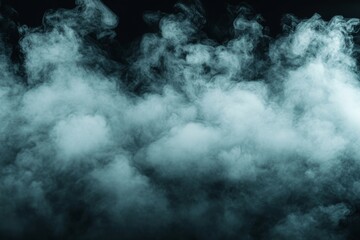 Soft gray smoke billows against a dark background creating an ethereal atmosphere in a low-light setting