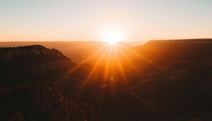Fototapeta premium Sunrise over vast canyon with glowing horizon