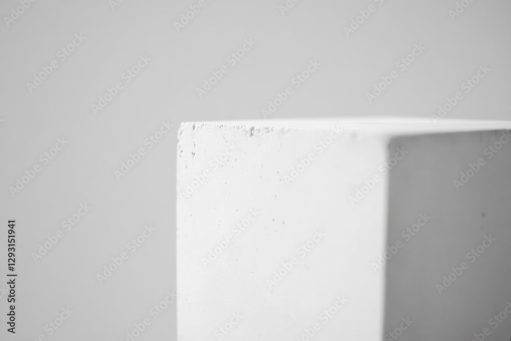 Fototapete Close-up view of a white concrete block showcasing texture and minimalistic design elements in a neutral background