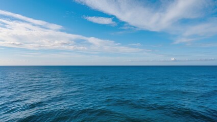 Obraz premium Tranquil Blue Sea Under a Clear Sky with Space for Text or Overlay Design