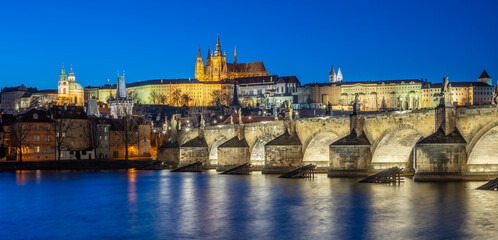 Panoramic night view of the iconic Charles Bridge over Vltava river and Prague Old town cityscape,...