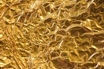 Golden shiny crumpled texture for design, background for text