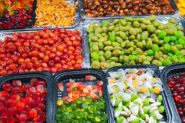 assortment of dried fruits, sweets, candies and marmalade on oriental market in Asia