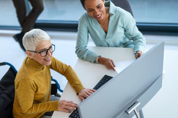 The image includes a person using a wheelchair, depicting inclusivity and teamwork in modern office