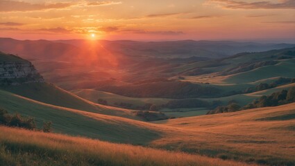 Serene sunset over rolling hills with vibrant orange hues illuminating the landscape creating a tranquil natural scene for relaxation and inspiration.