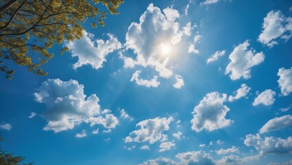 Vibrant blue sky with fluffy white clouds and sunlight creating a serene natural background for outdoor inspiration and nature themes.